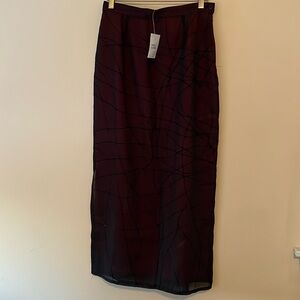 Embroidered and beaded long skirt has a slit up right side